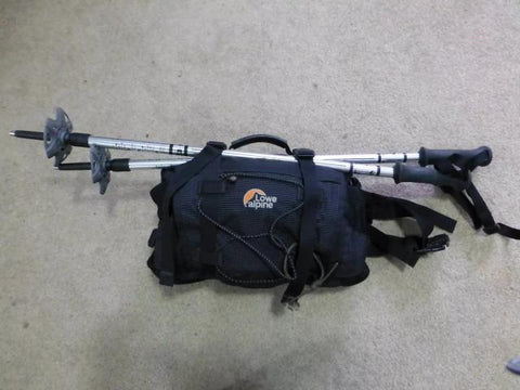 How to fix trekking poles to the backpack?