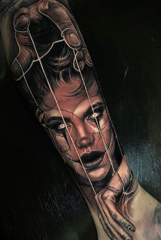 marionette arm tattoo
