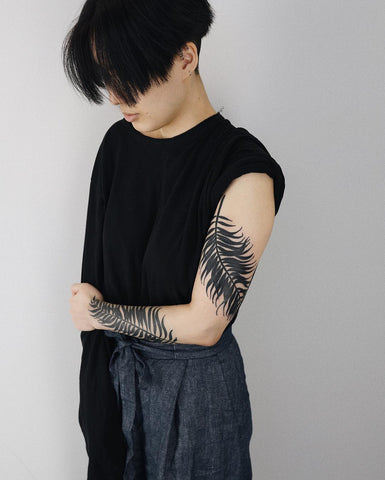 plant leaf tattoo on arms