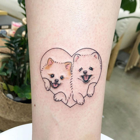 small dog tattoo in a heart frame