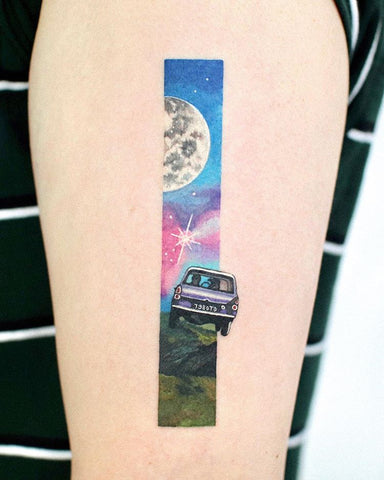 unique moon and car tattoo on arm