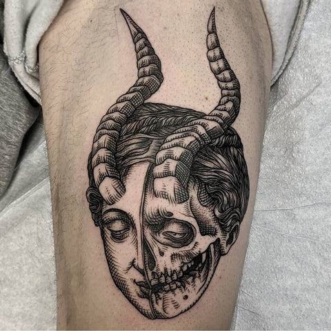 ram's horn men skull thigh tattoo