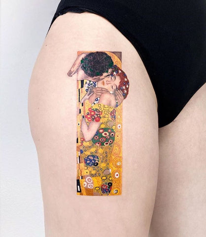 frame golden thigh tattoo