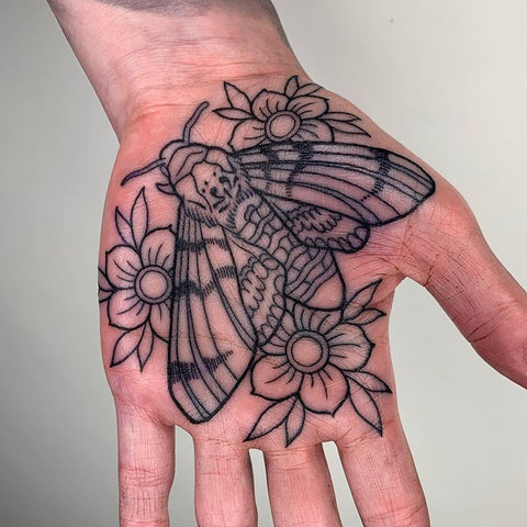 flower and bee moth tattoo on palm