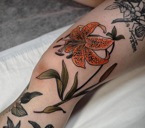 flower lily knee tattoo