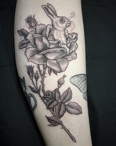 fine line flower rabbit tattoo