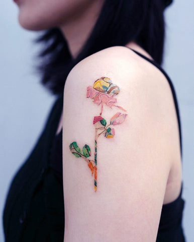 uniquely colored flower tattoo