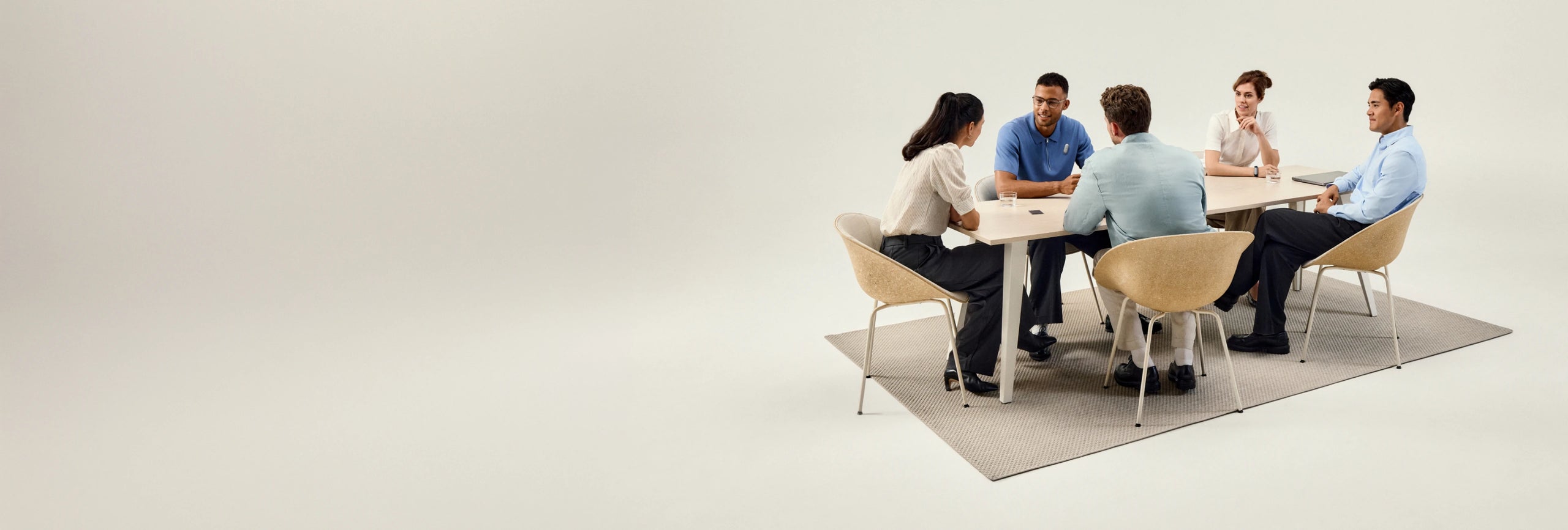 Five people in a meeting using a black Plaud Note Pro AI voice recorder on a conference table.