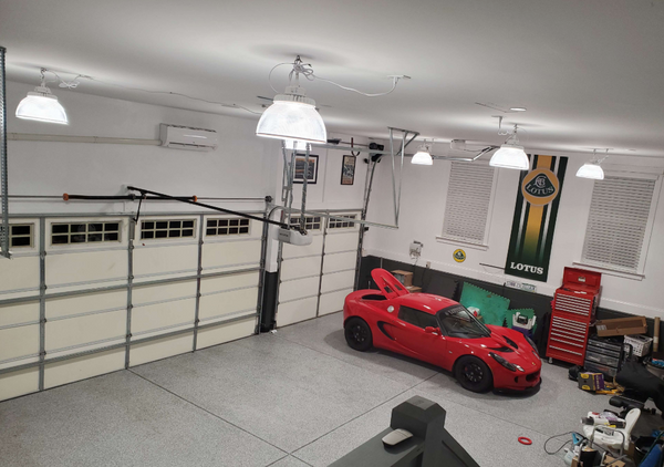The 2007 Lotus Exige is in garage installed led high bay lights with reflectors.