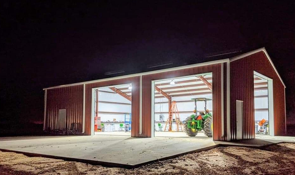 The LED high bay lights light up the farmhouse and the concrete pad.