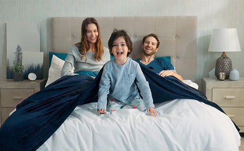 a family stay in one bed with Warm & Breathable Blankets
