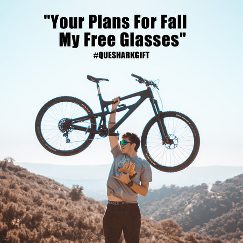 a man stand up hang bike wear queshark glasses