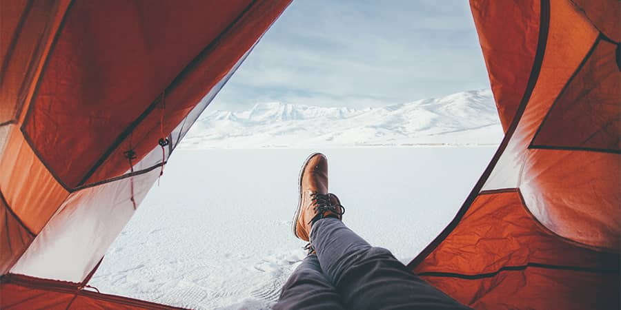 laying down view of mountains outside of tent