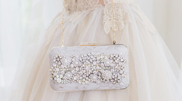 bride with white clutch bag for wedding