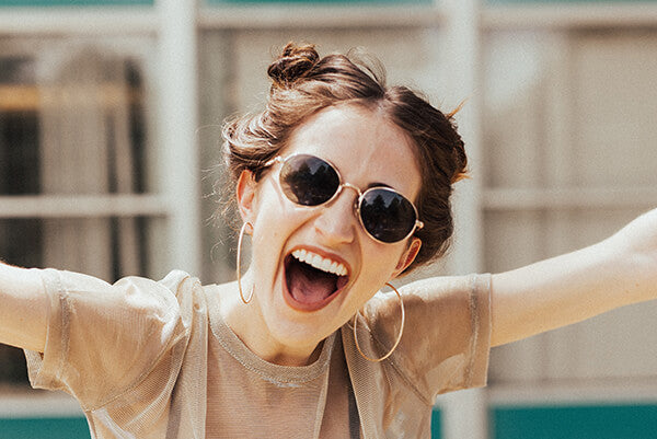 A happy woman wearing sunglasses