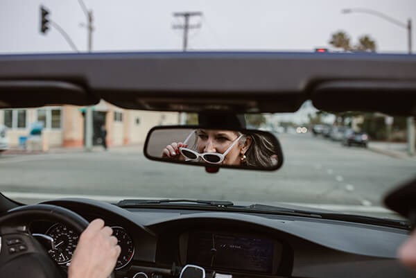 woman driving with sunglasses