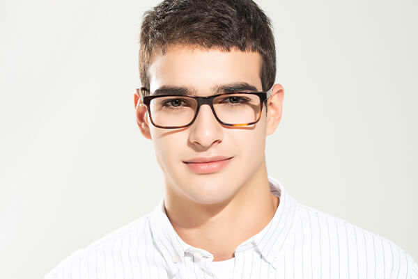 a man wearing tortoiseshell glasses