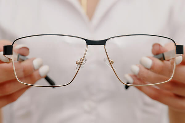 a woman holding glasses