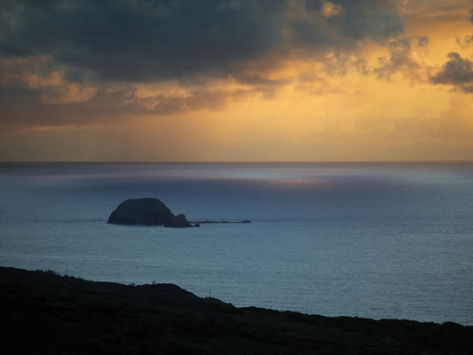 An Island Beneath Stormy Sunrise