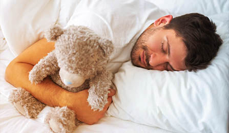 man_sleeping_with_a_stuffed_toy