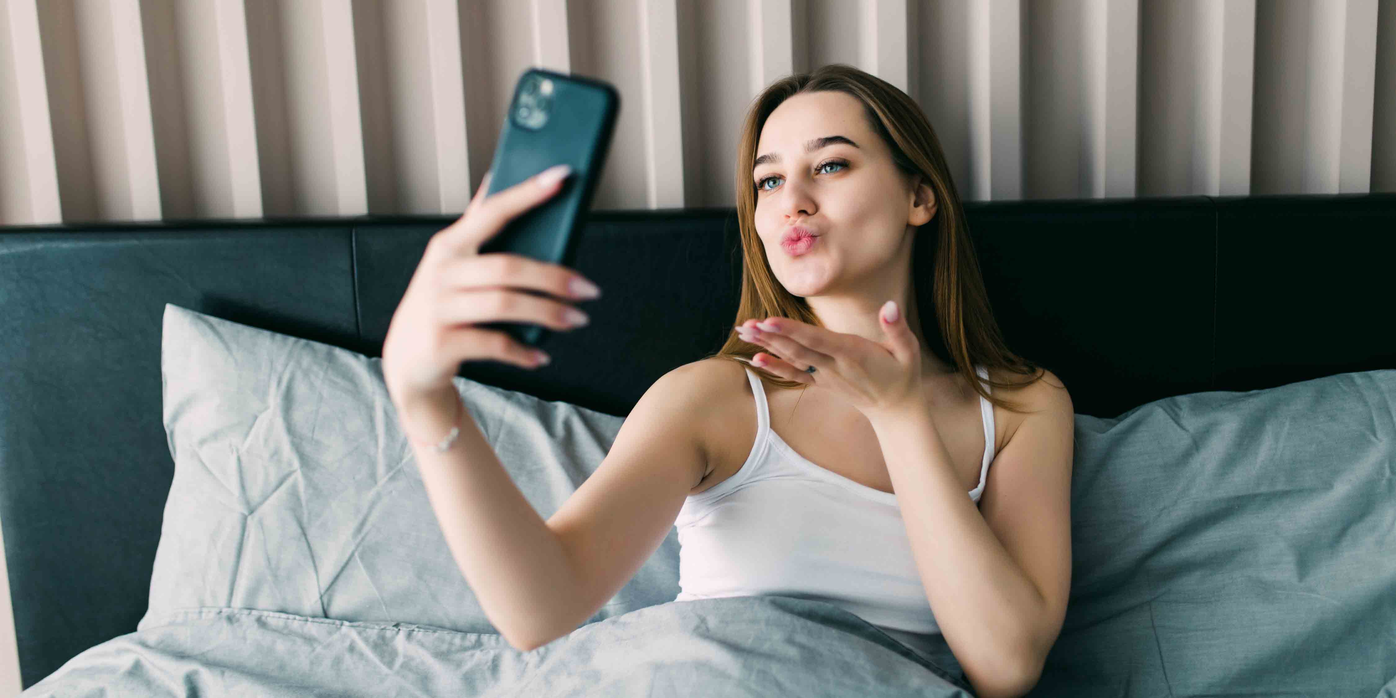 woman in bed with a phone