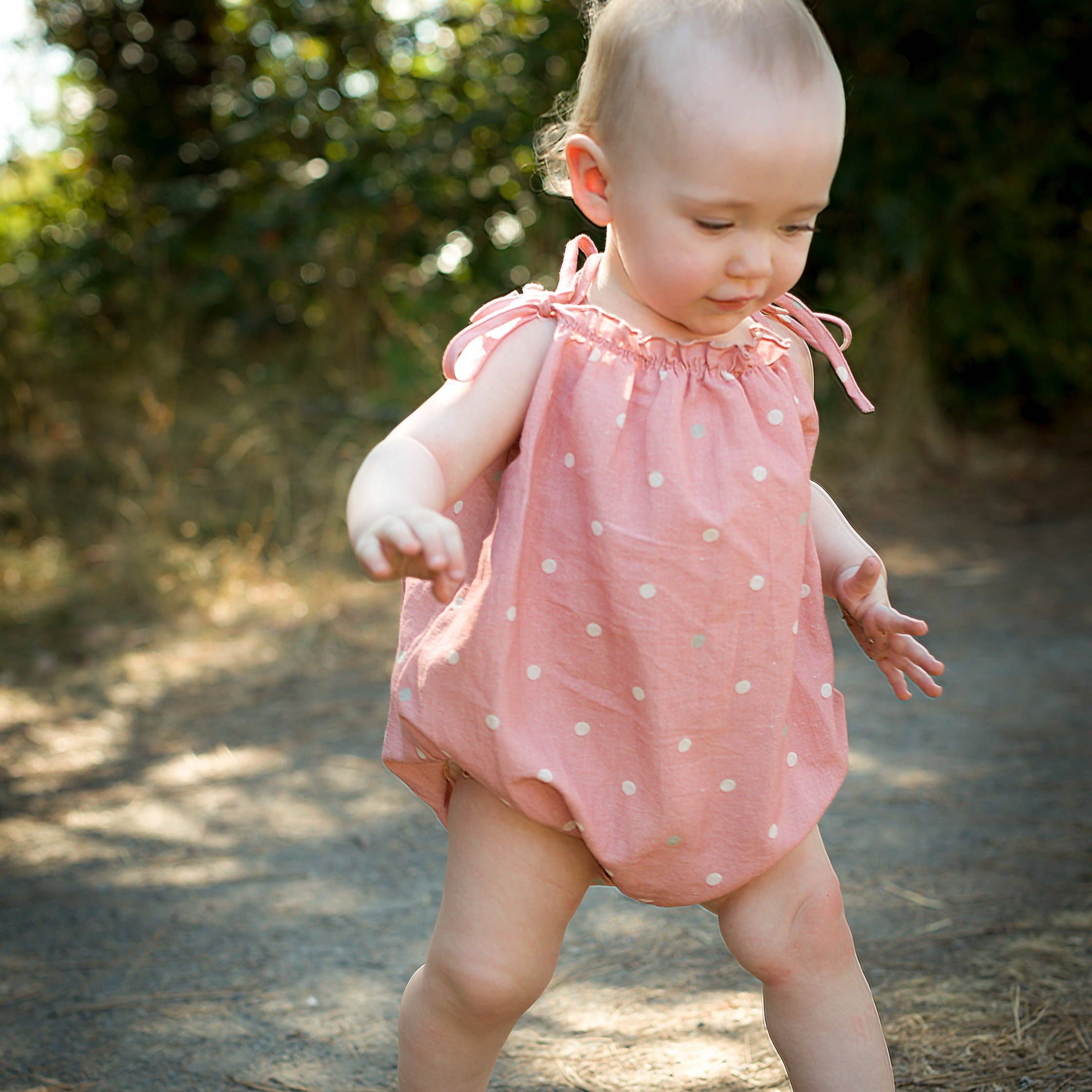 strap romper in pink polka dot