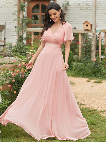 a girl wearing a long short sleeve chiffon pink bridesmaid dresses