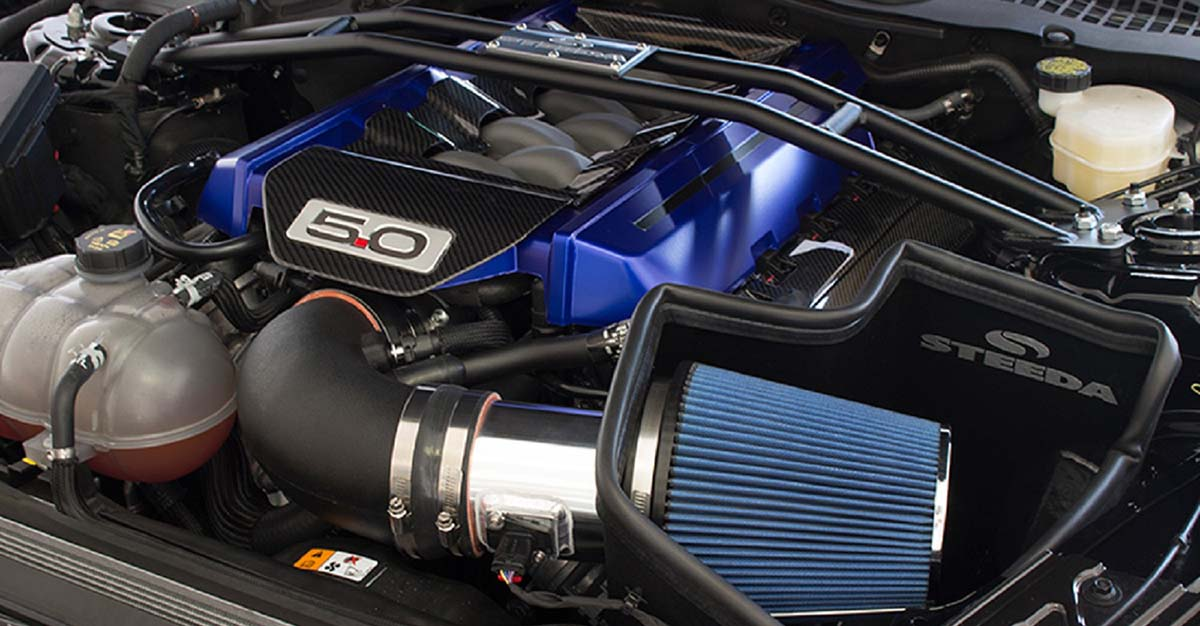 A SPELAB performance cold air intake kit with a blue filter installed on a modern truck engine.