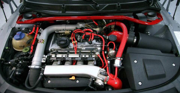 A mechanic checking a vacuum hose