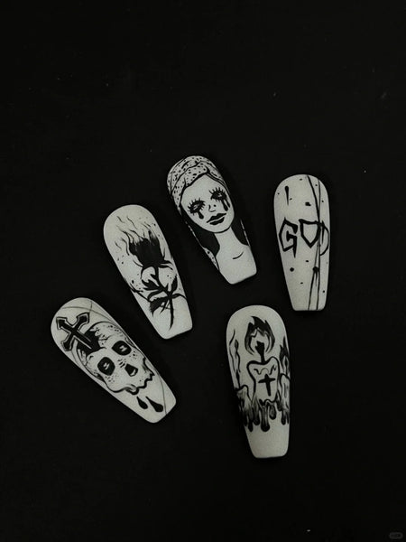 Black nail art stickers printed by phomemo label maker on the white nail tips.