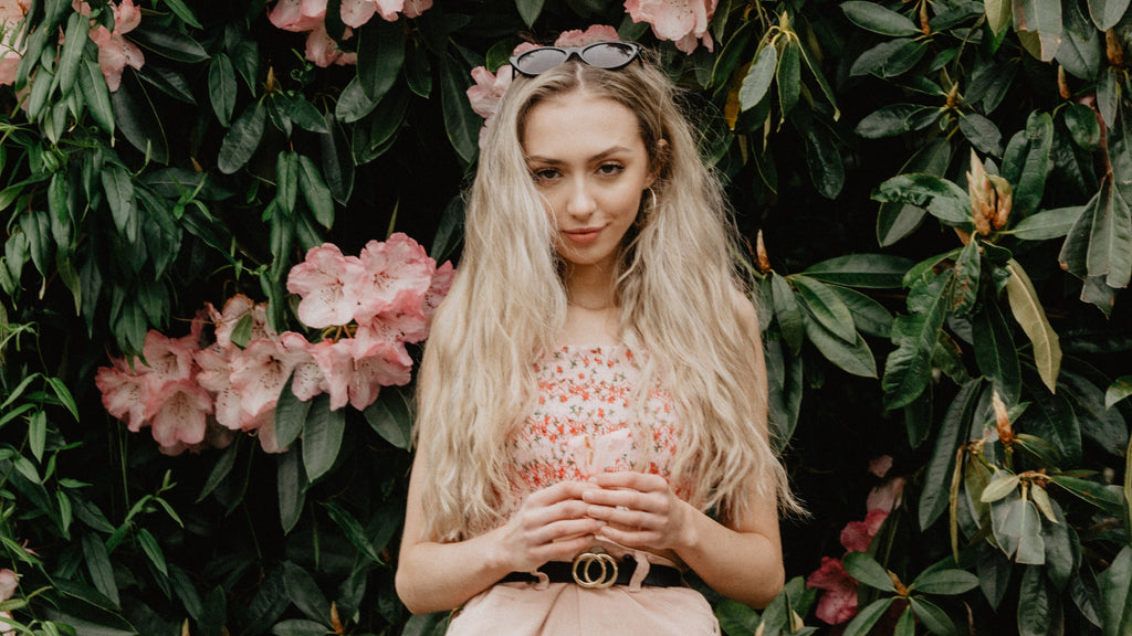 women wear sunglasses before flowers