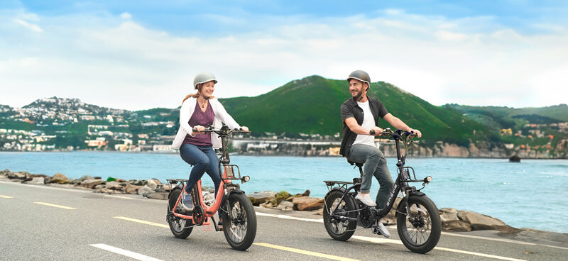 a man and a woman ride engwe l20 2.0 on the road