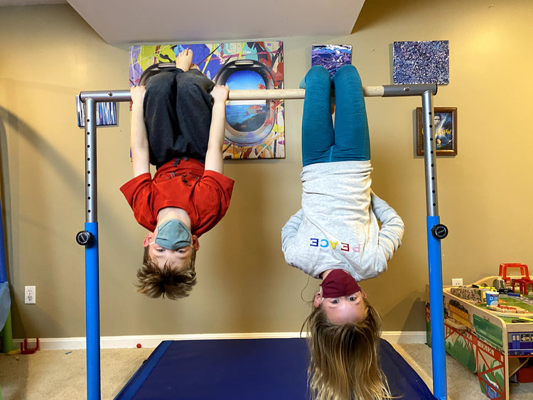A Boy and a Girl Exercising with a Gymnastics Bar with Solid Wood Bar