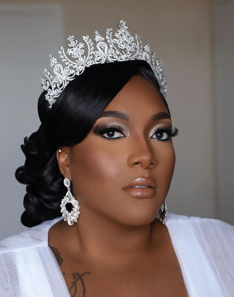 Curly Low Bun with a Side Part and a Tiara