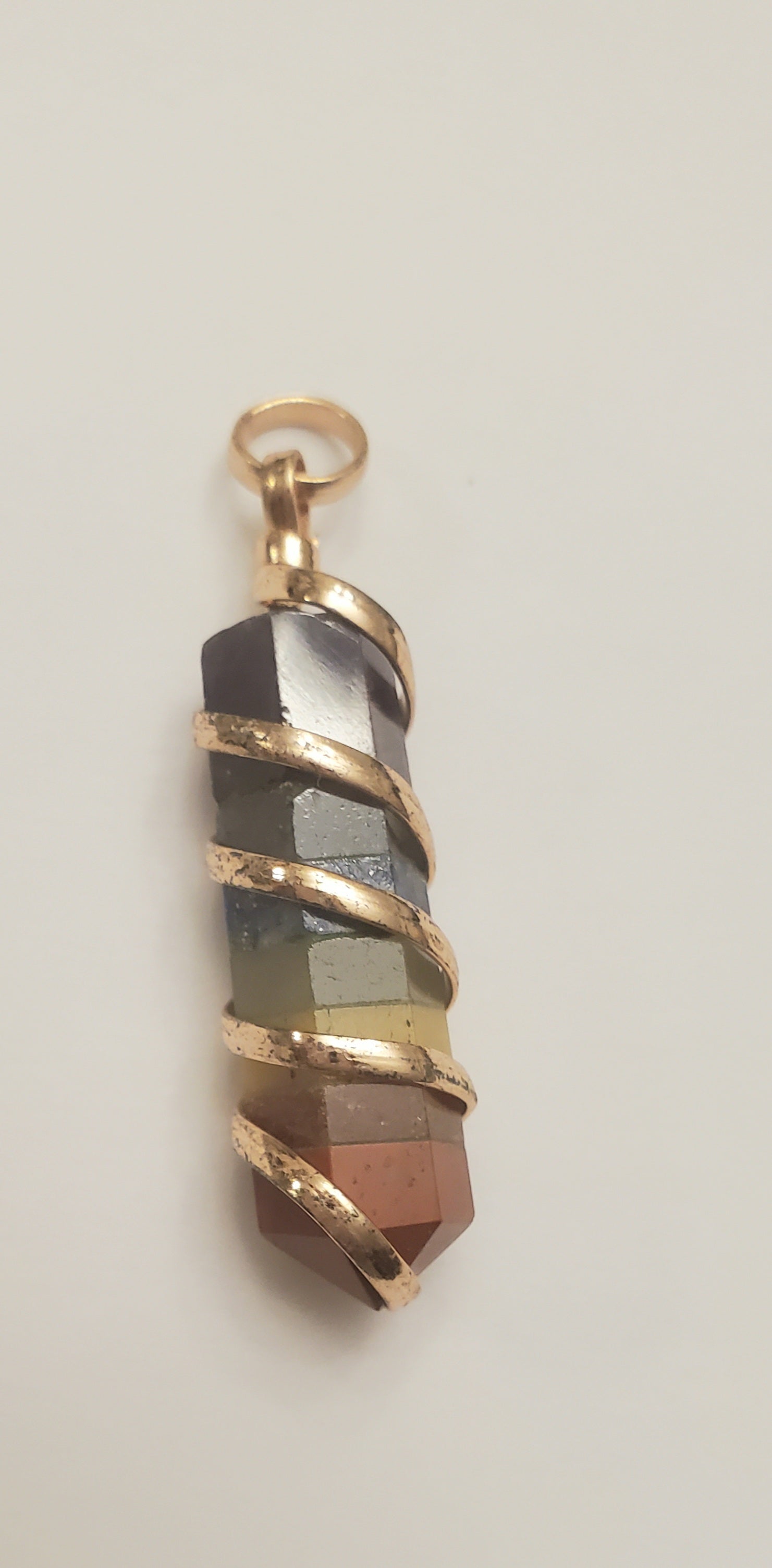 Coil wrapped crystal pendants