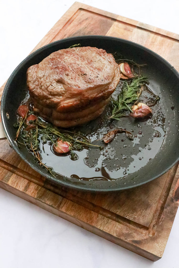 frying pan with piece of meat