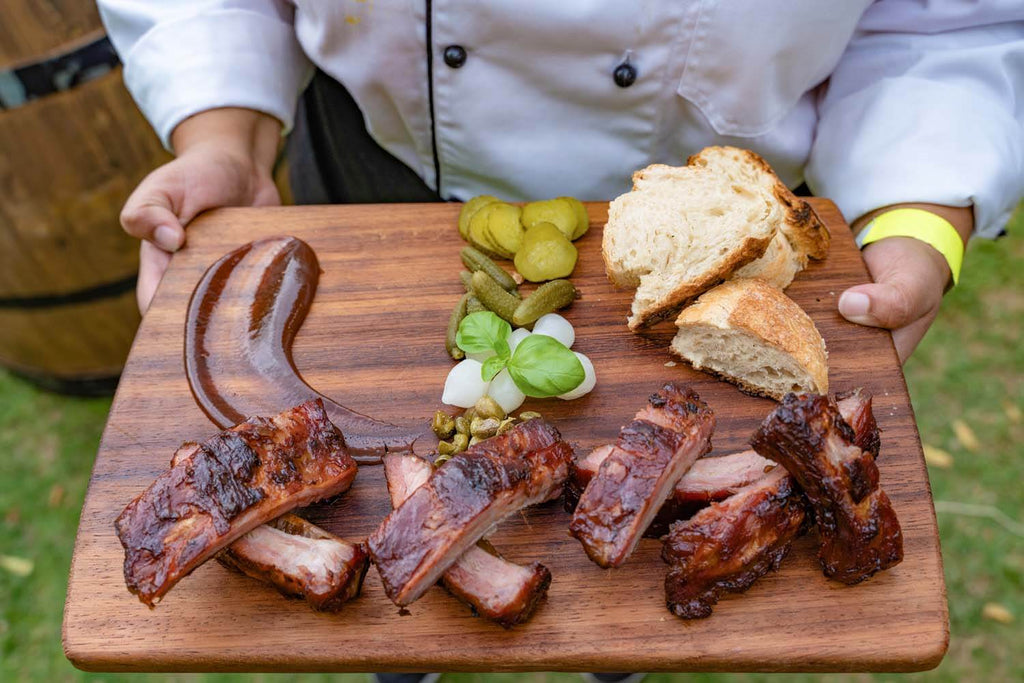 Grilled meat on wooden chopping board