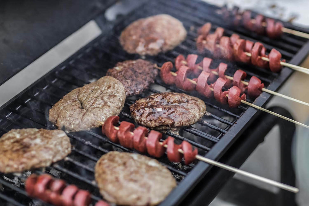 Grilled steak and sausage on outdoor grill