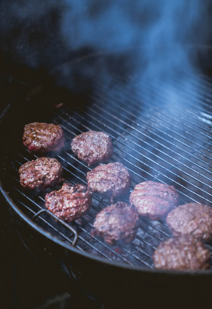 Grilling food on charcoal grill