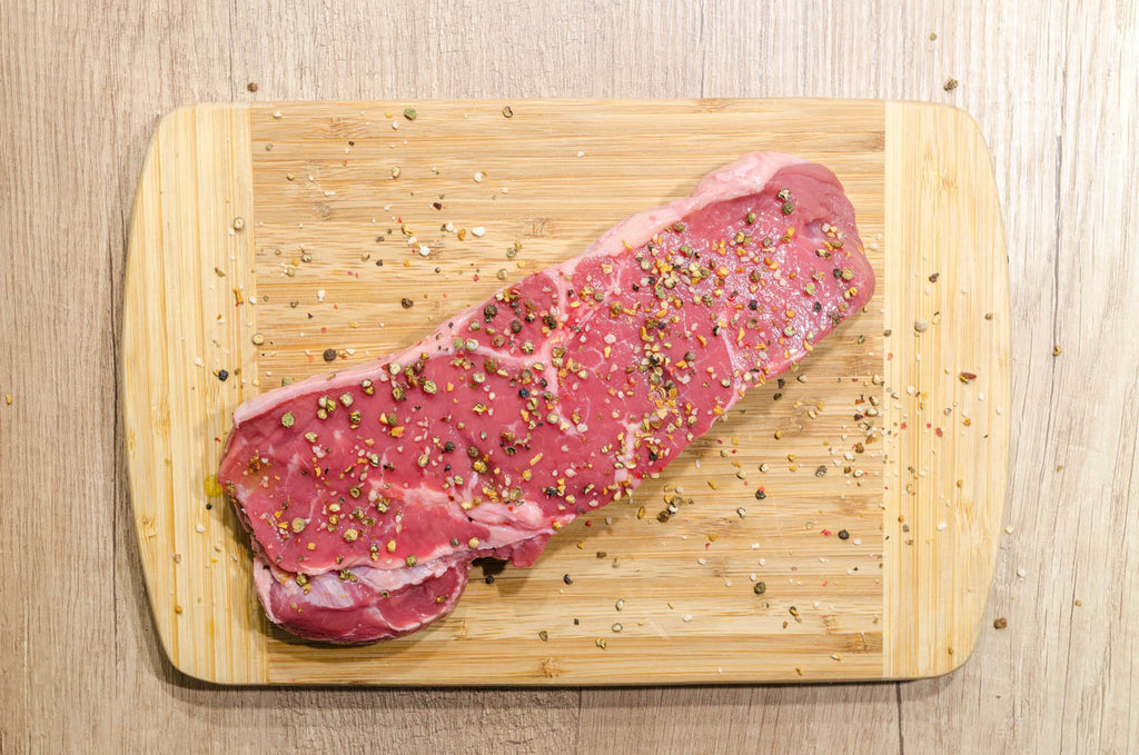 Slice of meat on chopping board