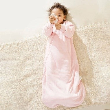 A baby wearing a Kaiya Baby sleep sack
