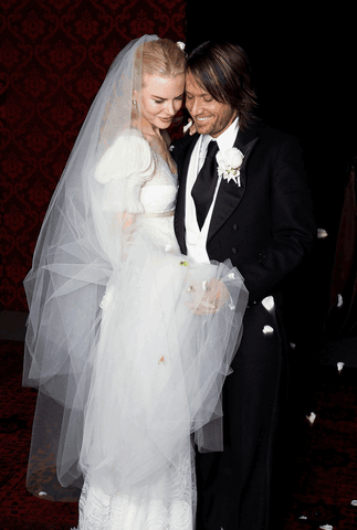 Nicole Kidman, wearing an ivory wedding dress.