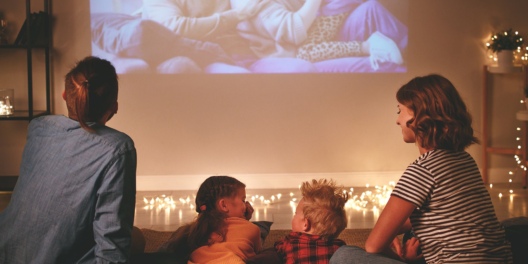 a family gather together to have a home movie party