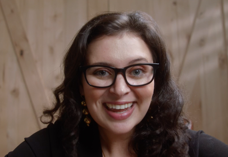 Caucasian woman taking Zoom video call with Vue Lite Cygnus eyeglasses and smiling