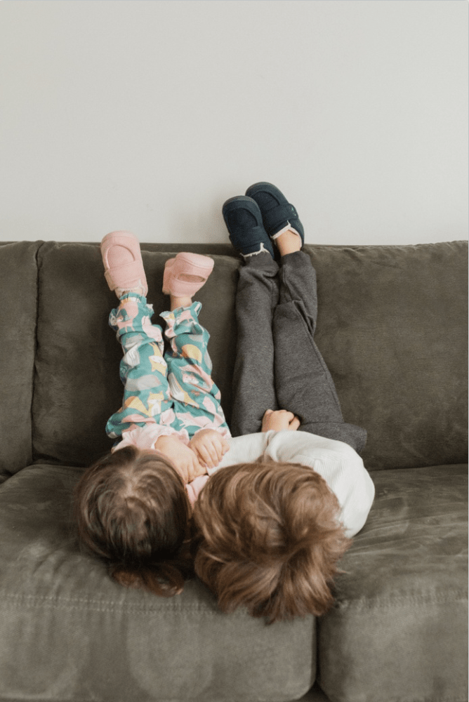 Two kids playing in slippers