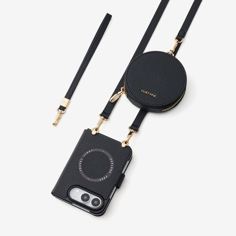 Black leather crossbody iPhone Duo case with a matching round coin pouch and wrist strap, featuring gold-tone hardware and a MagSafe ring