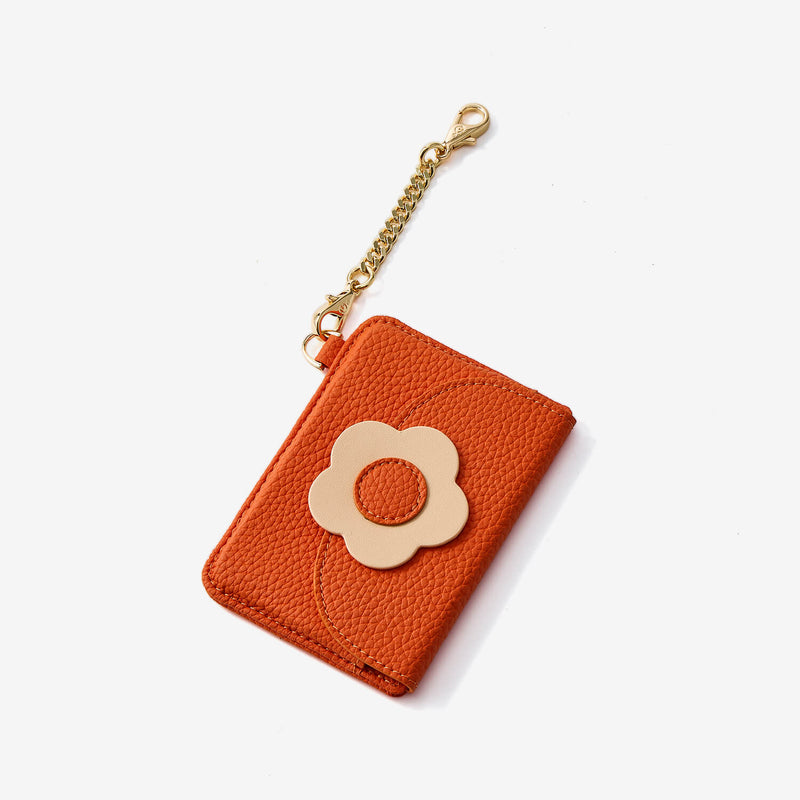 Orange leather cardholder with a flower