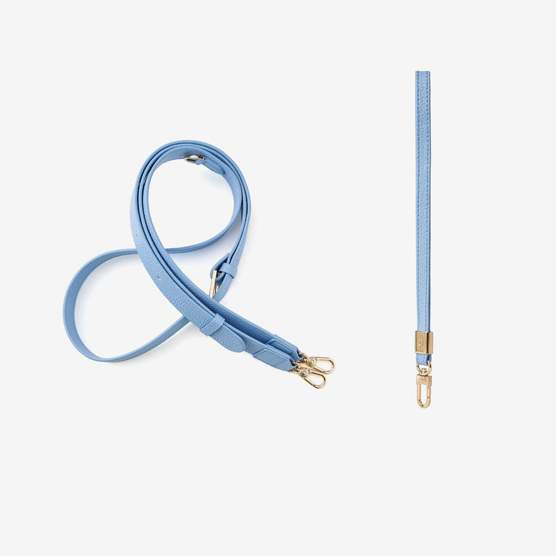 blue crossbody strap and wrist strap with gold hardware