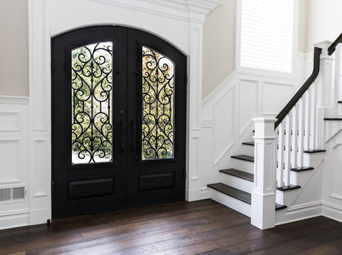 wrought iron entry door with scrollwork and arched top