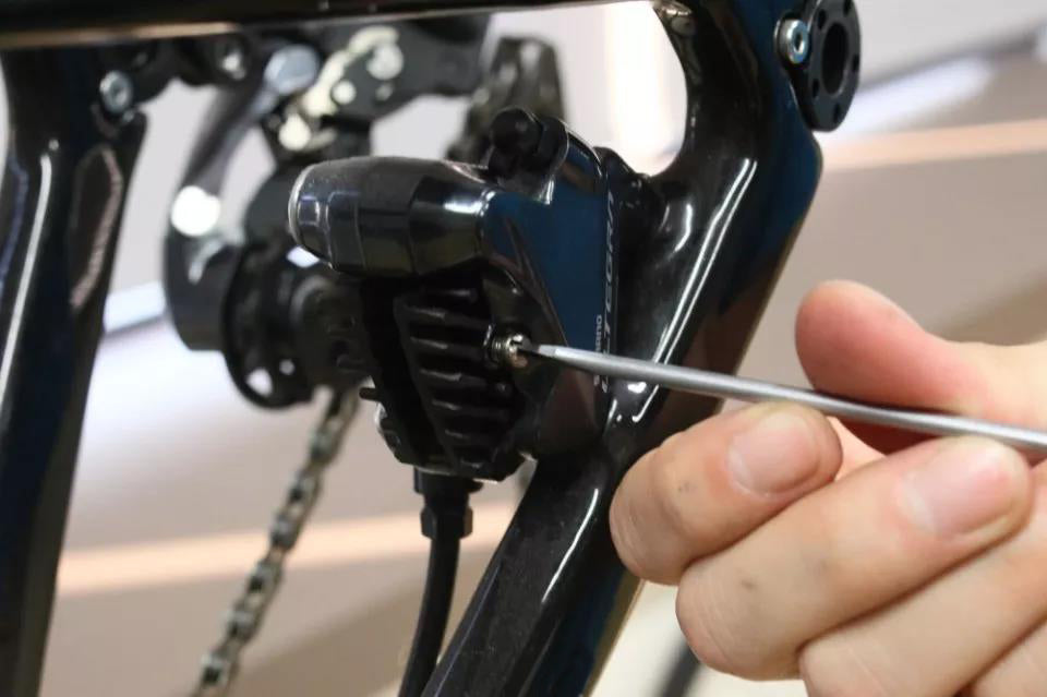 Use a flat-head screwdriver to remove the fixing bolts